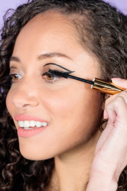 Model putting on mascara